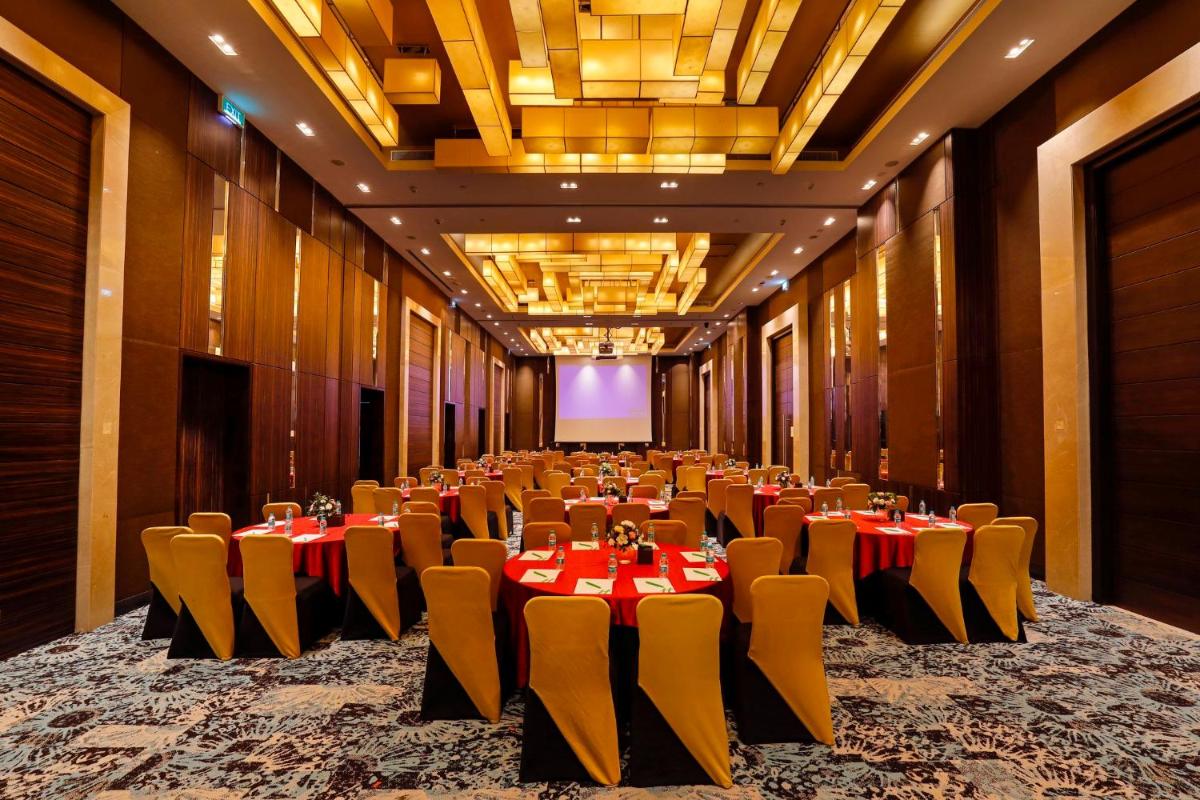 a large banquet hall with tables and chairs in it at Holiday Inn Chennai OMR IT Expressway by IHG in Chennai