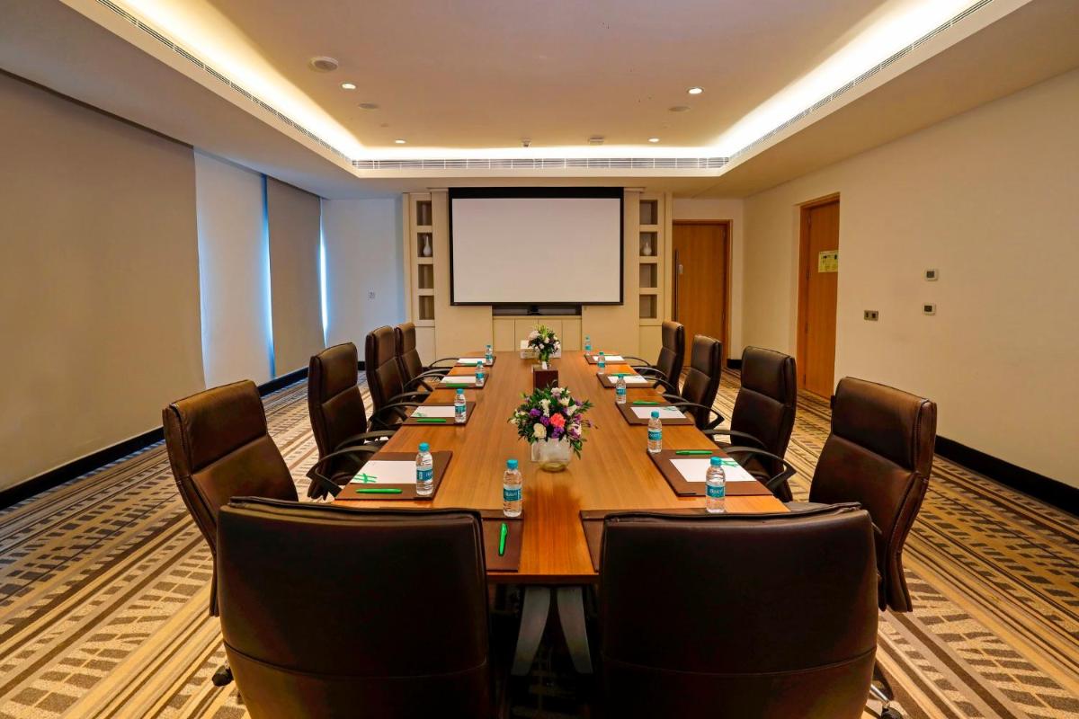 a large conference room with a long table and chairs at Holiday Inn Chennai OMR IT Expressway by IHG in Chennai