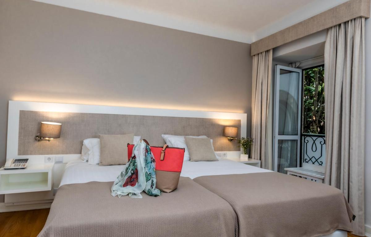 Uma cama ou camas num quarto em Grande Hotel das Caldas da Felgueira