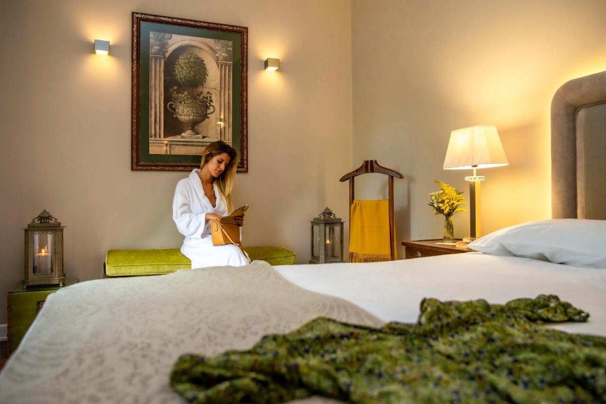 Uma cama ou camas num quarto em Grande Hotel das Caldas da Felgueira