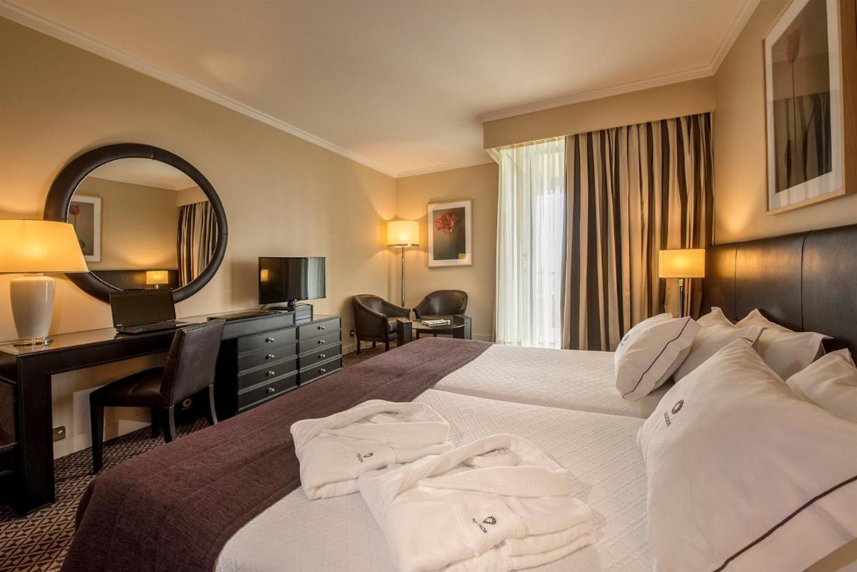 Uma cama ou camas num quarto em Hotel Solverde Spa and Wellness Center