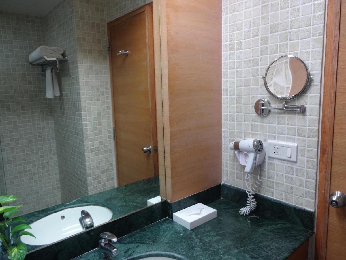 a bathroom with a sink and a mirror at Park Plaza Chennai OMR in Chennai