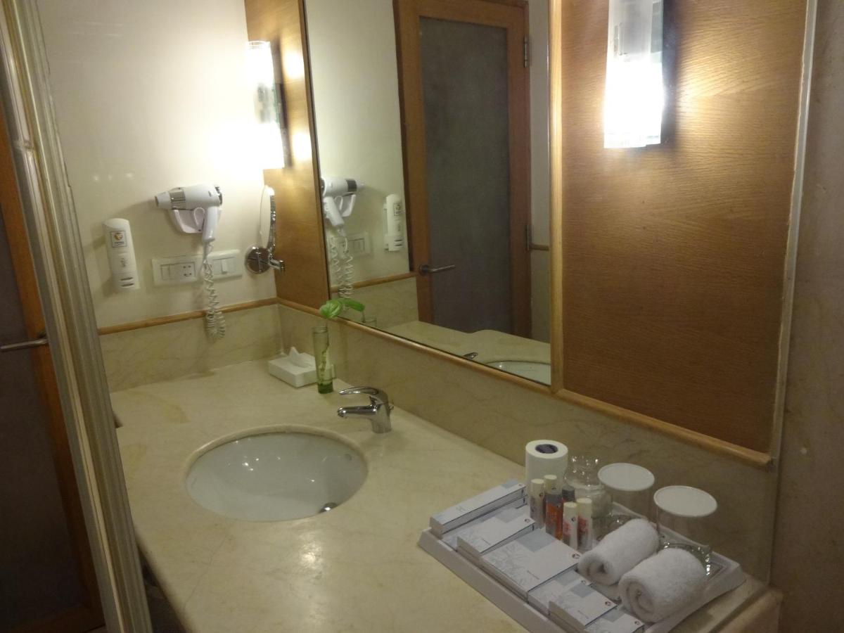a bathroom with a sink and a large mirror at Park Plaza Chennai OMR in Chennai