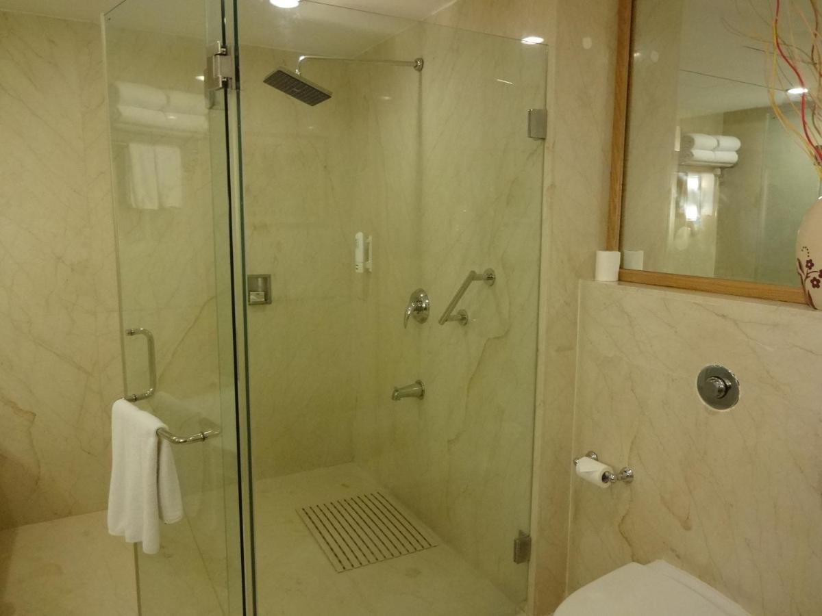 a shower with a glass door in a bathroom at Park Plaza Chennai OMR in Chennai