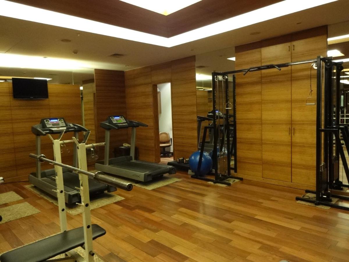 a gym with several tread machines in a room at Park Plaza Chennai OMR in Chennai
