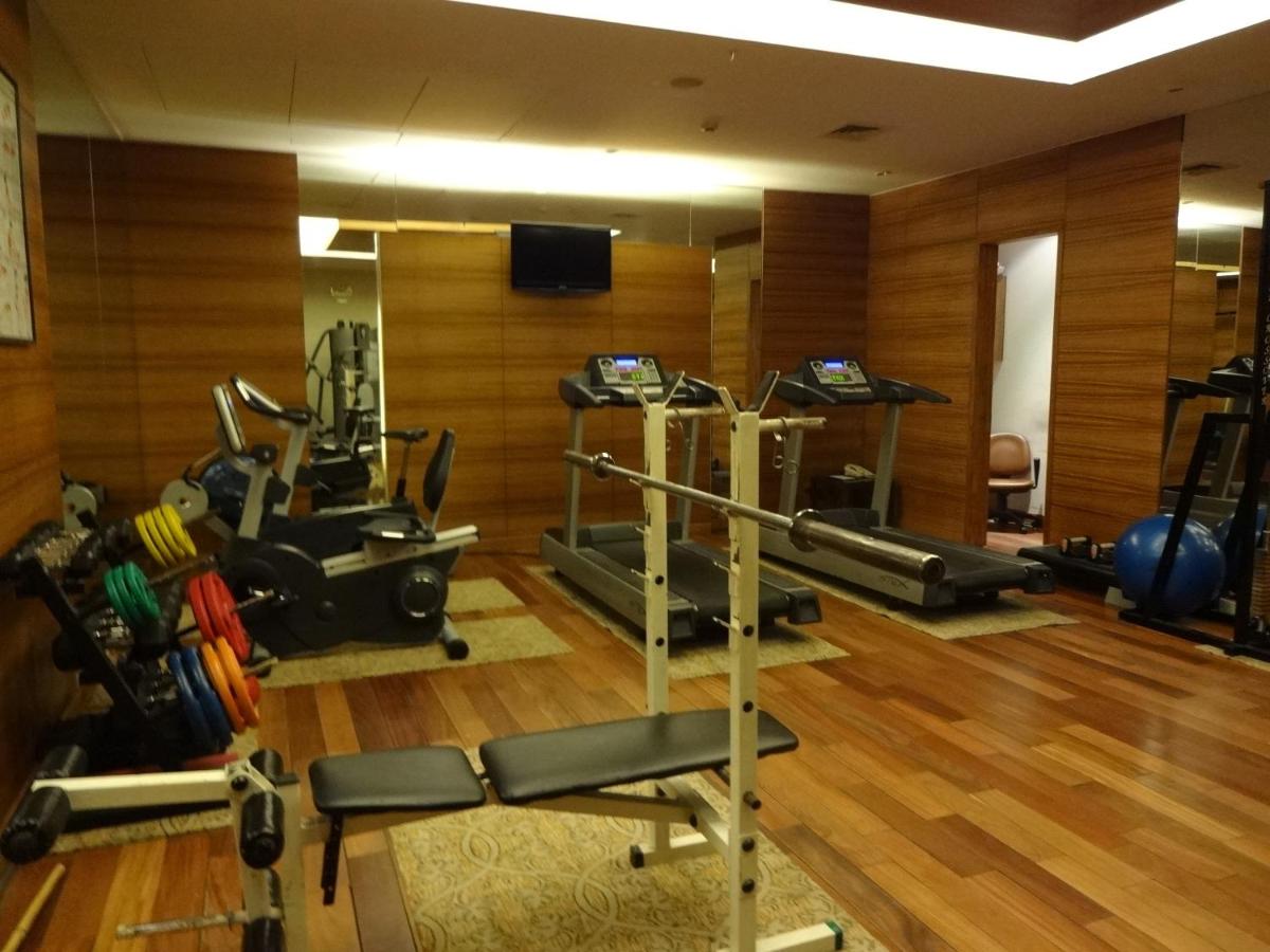 a gym with several treadmills and exercise machines at Park Plaza Chennai OMR in Chennai