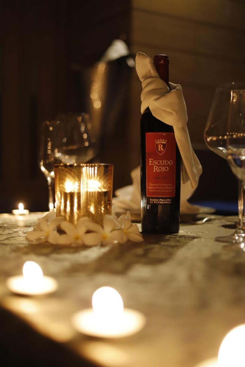 a bottle of wine sitting on a table with a glass at InterContinental Jaipur Tonk Road by IHG in Jaipur