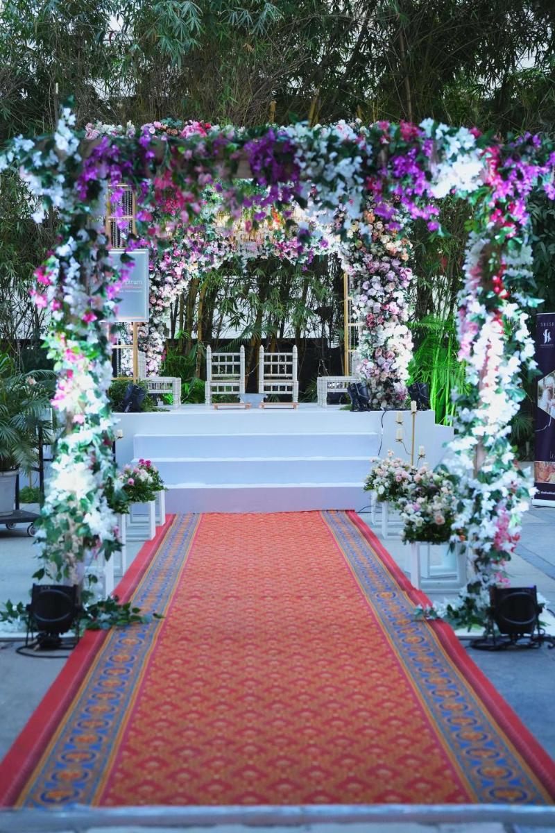 an arch with a red carpet and flowers at Radisson Blu Hotel Pune Kharadi in Pune