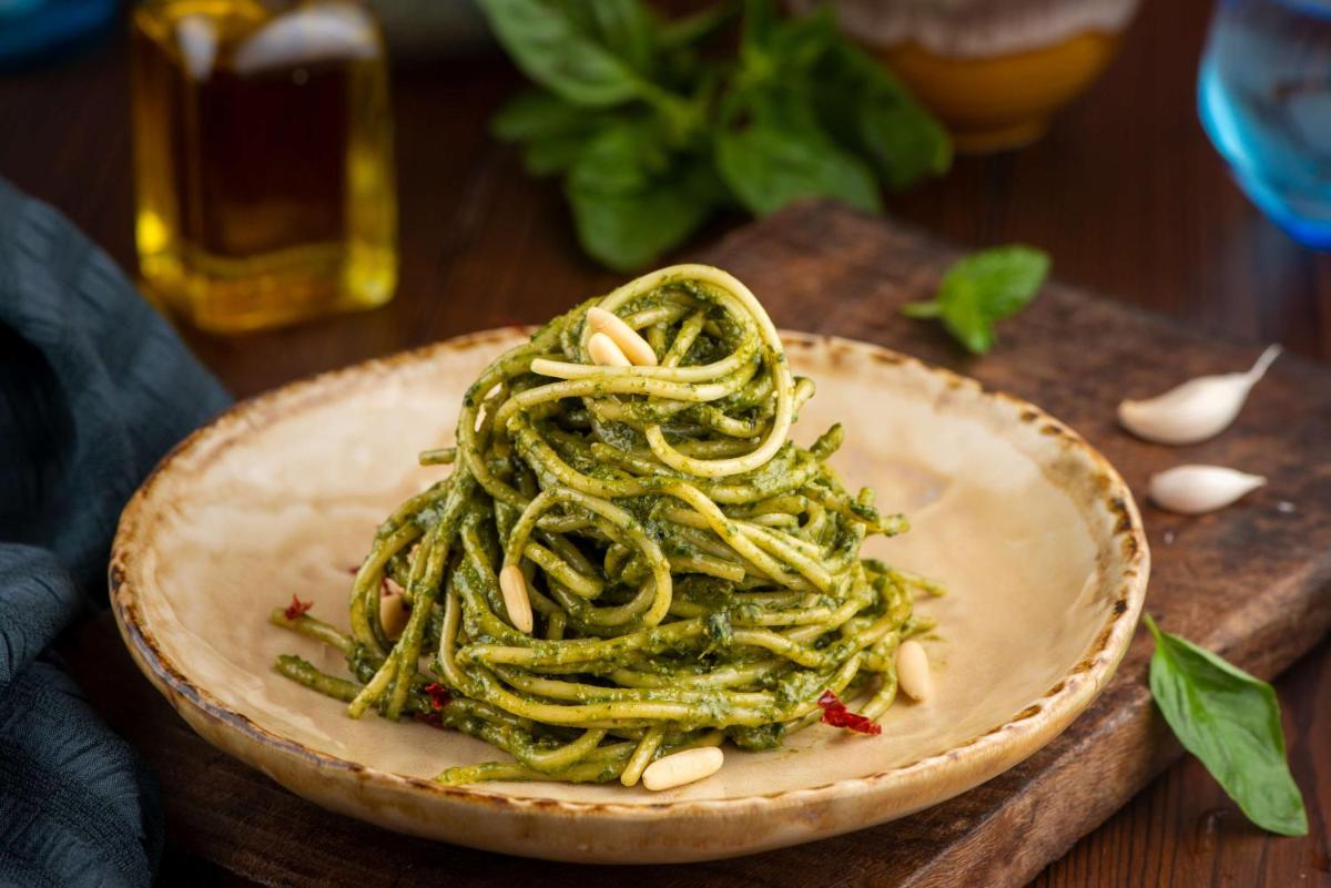 a bowl of pasta with peanuts on a wooden table at Radisson Blu Plaza Delhi Airport in New Delhi a bowl of pasta with peanuts on a wooden table at Radisson Blu Plaza Delhi Airport in New Delhi
