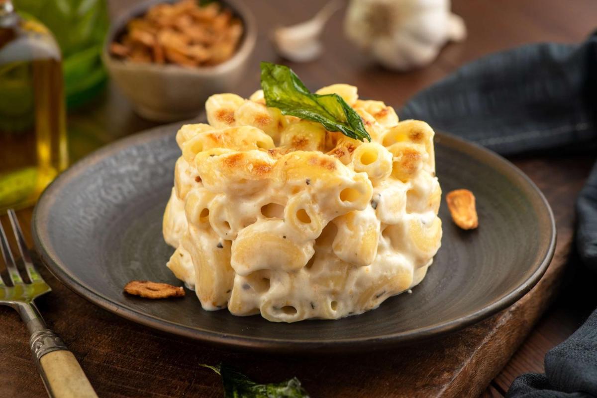 a plate of food with pasta on a table at Radisson Blu Plaza Delhi Airport in New Delhi a plate of food with pasta on a table at Radisson Blu Plaza Delhi Airport in New Delhi