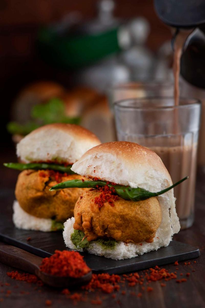 three fried chicken sandwiches on a table with a glass of milk at Radisson Blu Plaza Delhi Airport in New Delhi three fried chicken sandwiches on a table with a glass of milk at Radisson Blu Plaza Delhi Airport in New Delhi