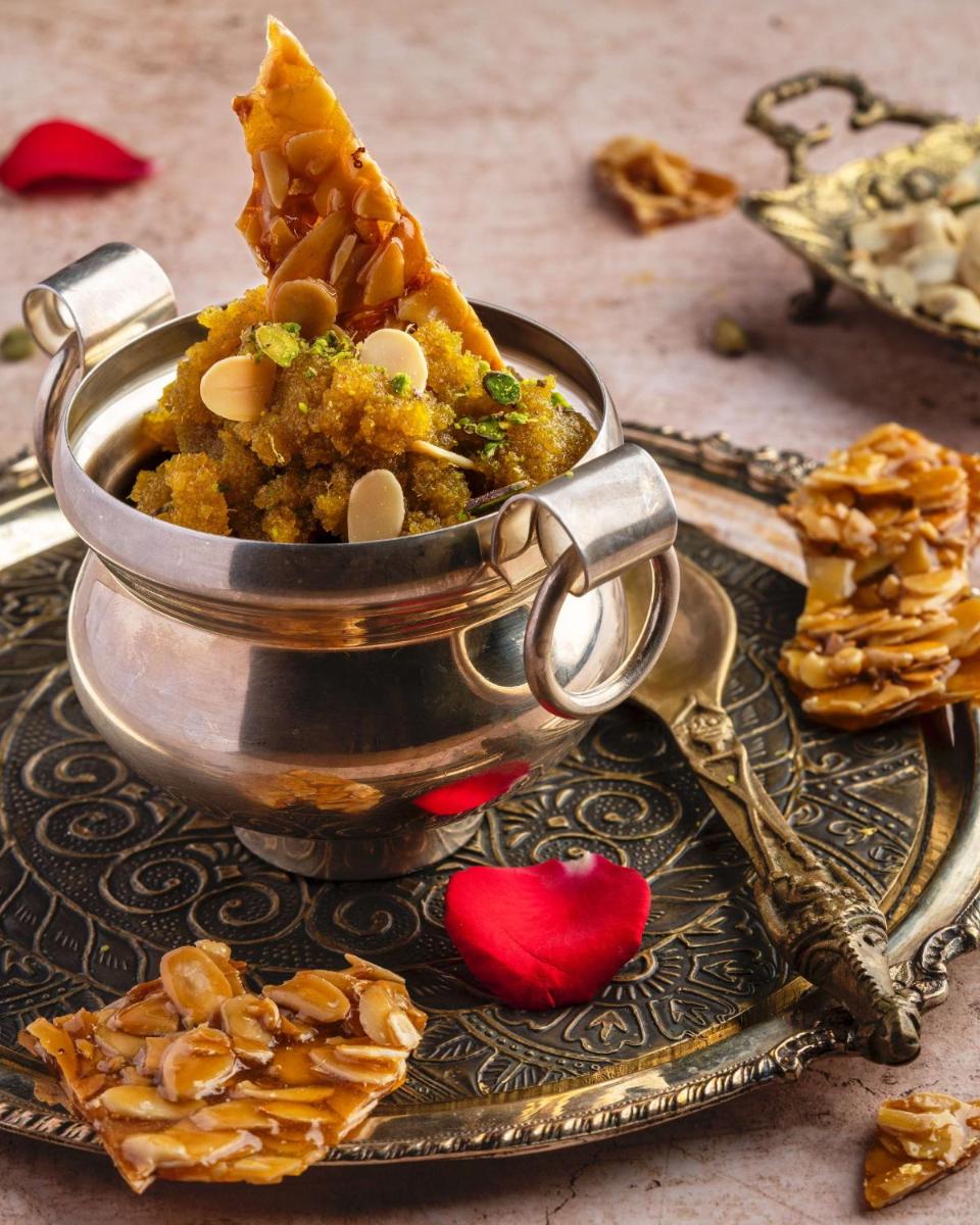 a metal container filled with food on a plate at Radisson Blu Plaza Delhi Airport in New Delhi a metal container filled with food on a plate at Radisson Blu Plaza Delhi Airport in New Delhi