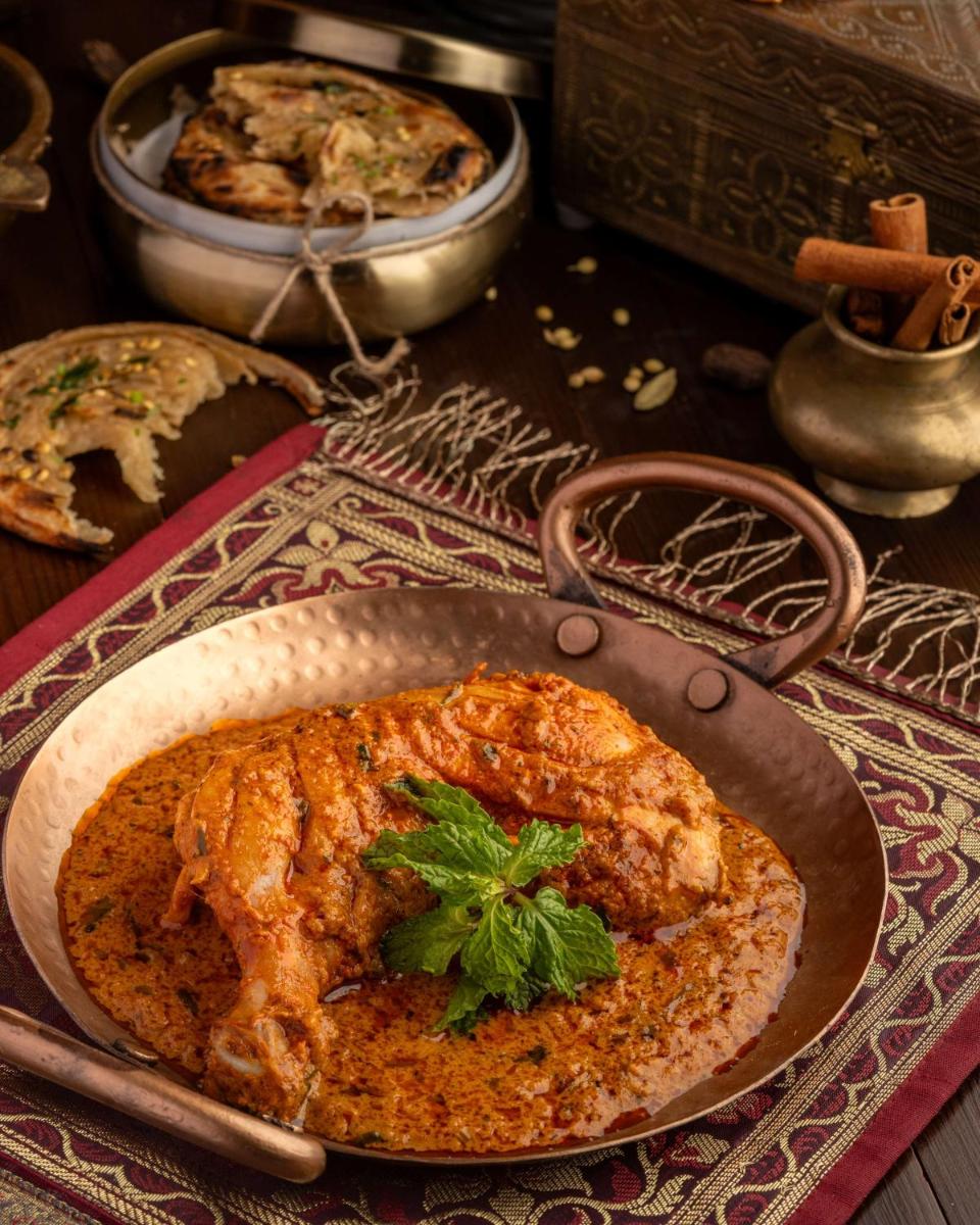 a table with a plate of food on a table at Radisson Blu Plaza Delhi Airport in New Delhi a table with a plate of food on a table at Radisson Blu Plaza Delhi Airport in New Delhi