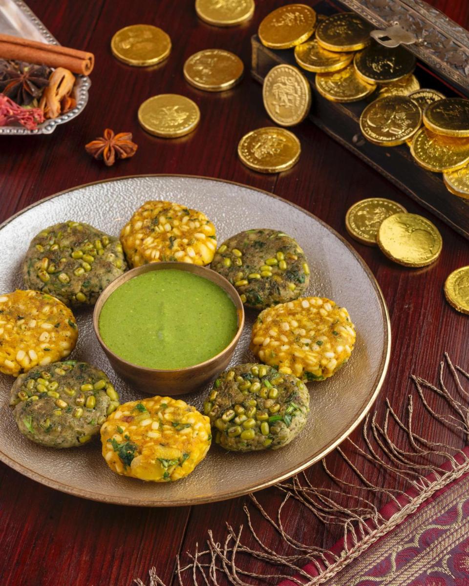 a plate of food with green dip and gold coins at Radisson Blu Plaza Delhi Airport in New Delhi a plate of food with green dip and gold coins at Radisson Blu Plaza Delhi Airport in New Delhi