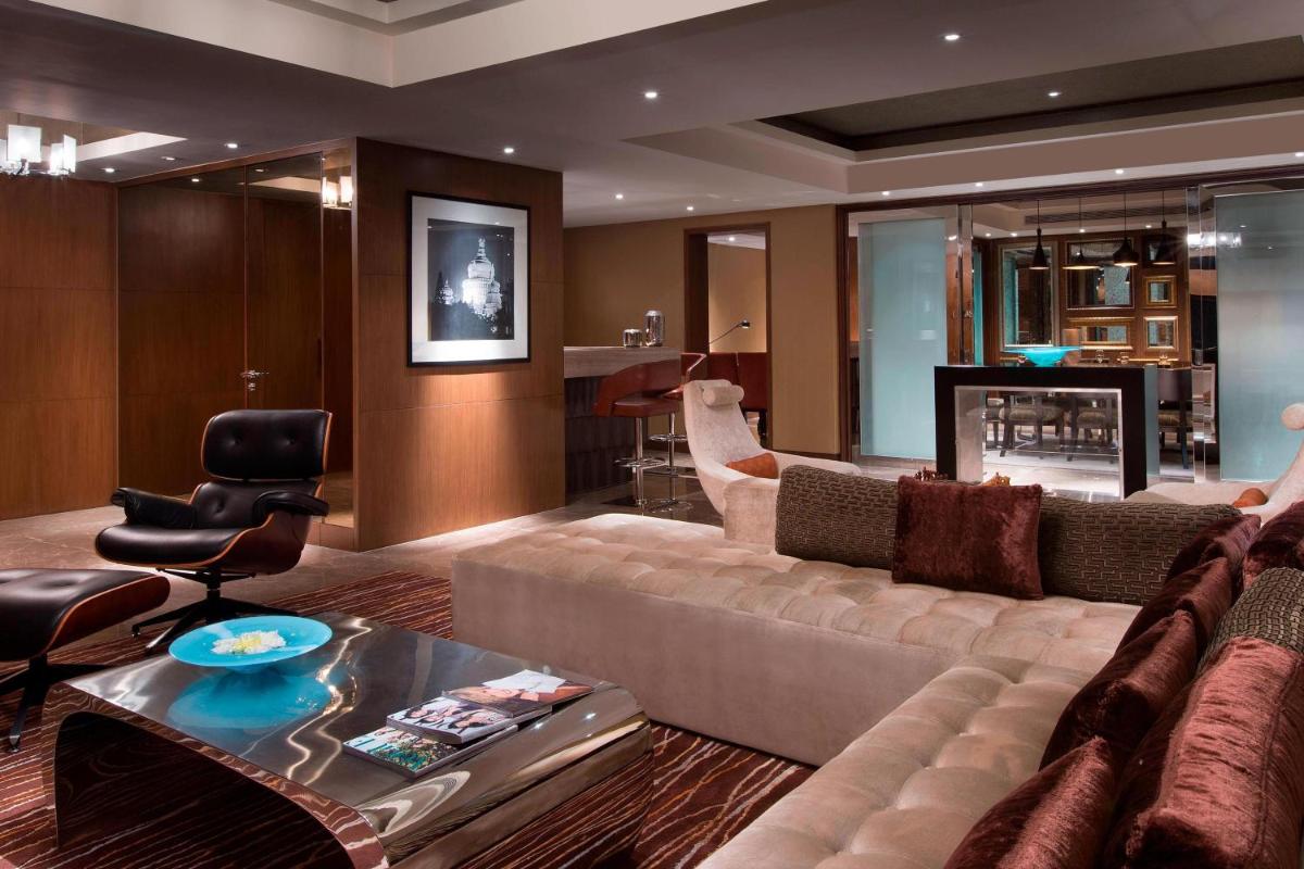 a living room with a couch and a table at Sheraton Grand Bangalore Hotel at Brigade Gateway in Bengaluru