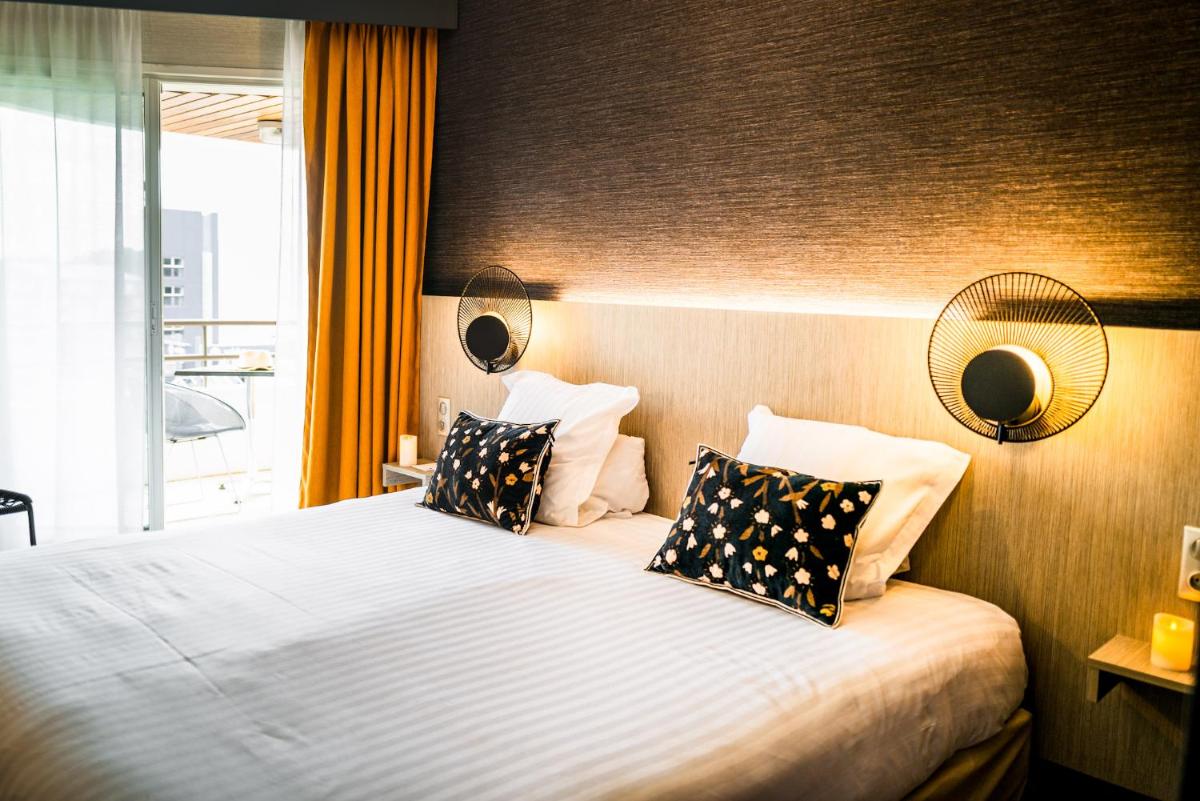 Un ou plusieurs lits dans un hébergement de l'établissement Hôtel Valdys Thalasso & Spa - les Pins