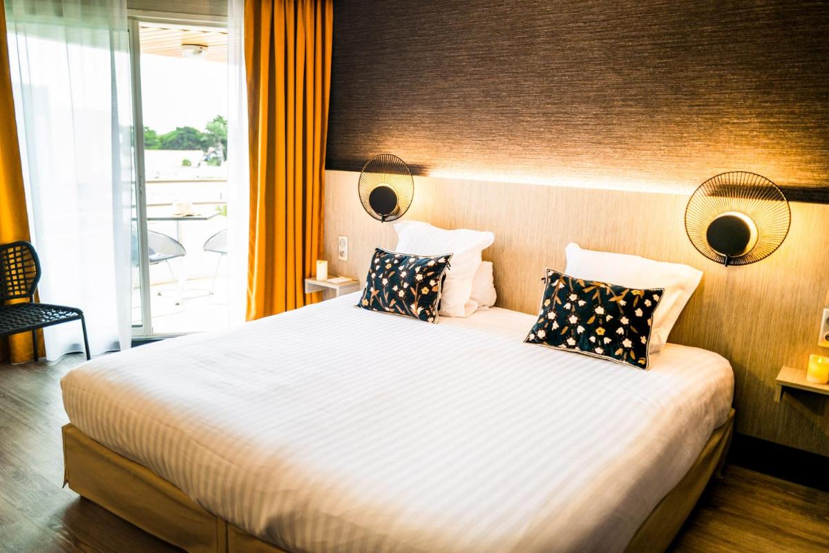 Un ou plusieurs lits dans un hébergement de l'établissement Hôtel Valdys Thalasso & Spa - les Pins