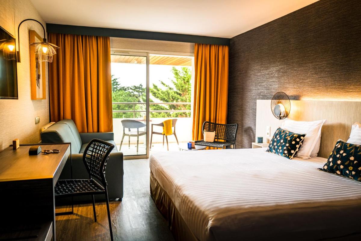 Un ou plusieurs lits dans un hébergement de l'établissement Hôtel Valdys Thalasso & Spa - les Pins