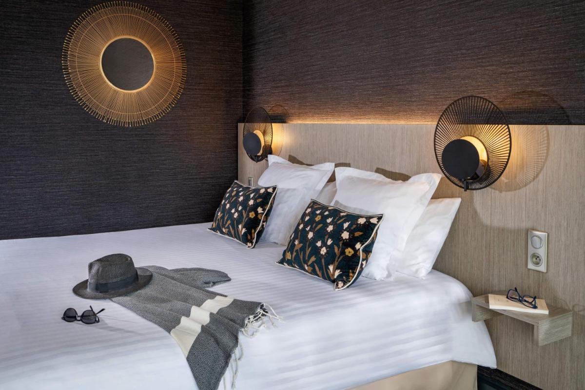 Un ou plusieurs lits dans un hébergement de l'établissement Hôtel Valdys Thalasso & Spa - les Pins