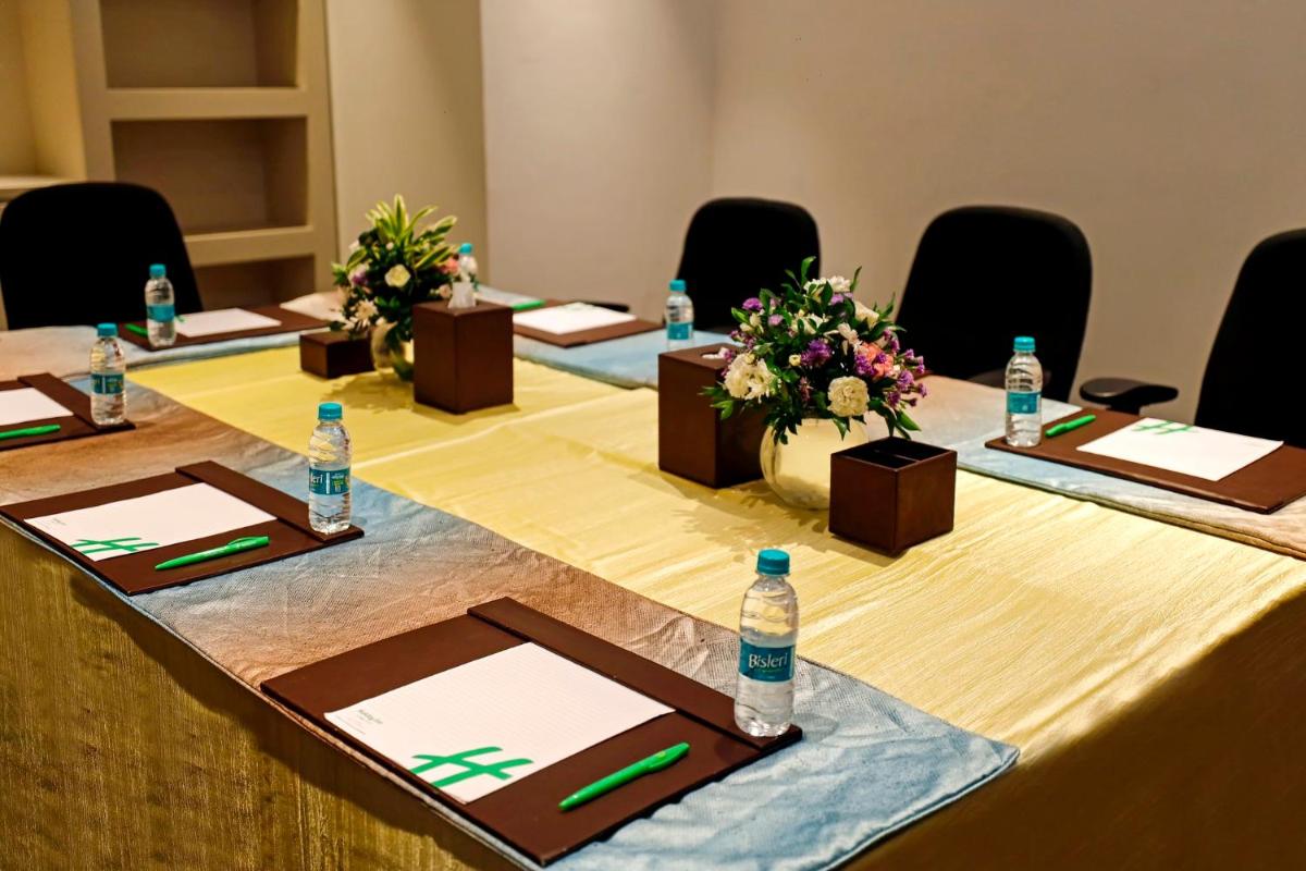 a meeting room with a long table with bottles of water at Holiday Inn Chennai OMR IT Expressway by IHG in Chennai