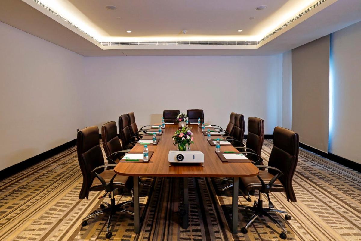 a conference room with a long table and chairs at Holiday Inn Chennai OMR IT Expressway by IHG in Chennai