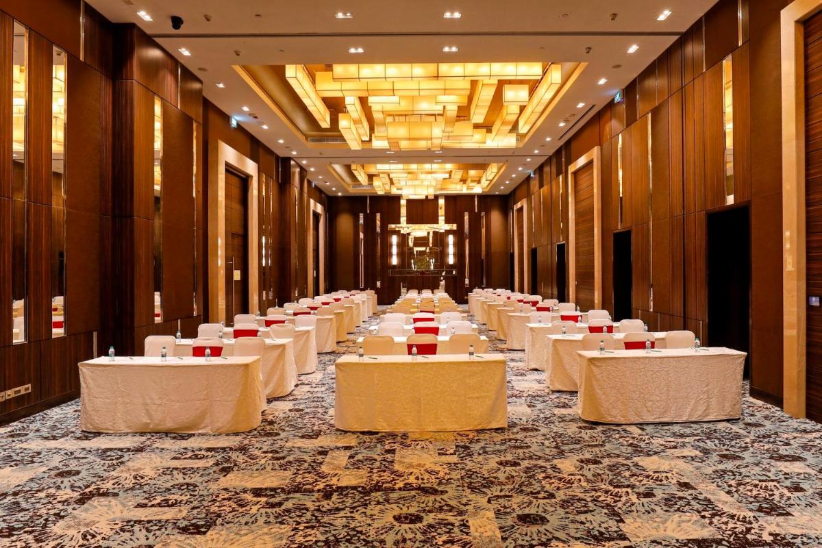 a row of tables in a banquet hall with white tablesearcher at Holiday Inn Chennai OMR IT Expressway by IHG in Chennai