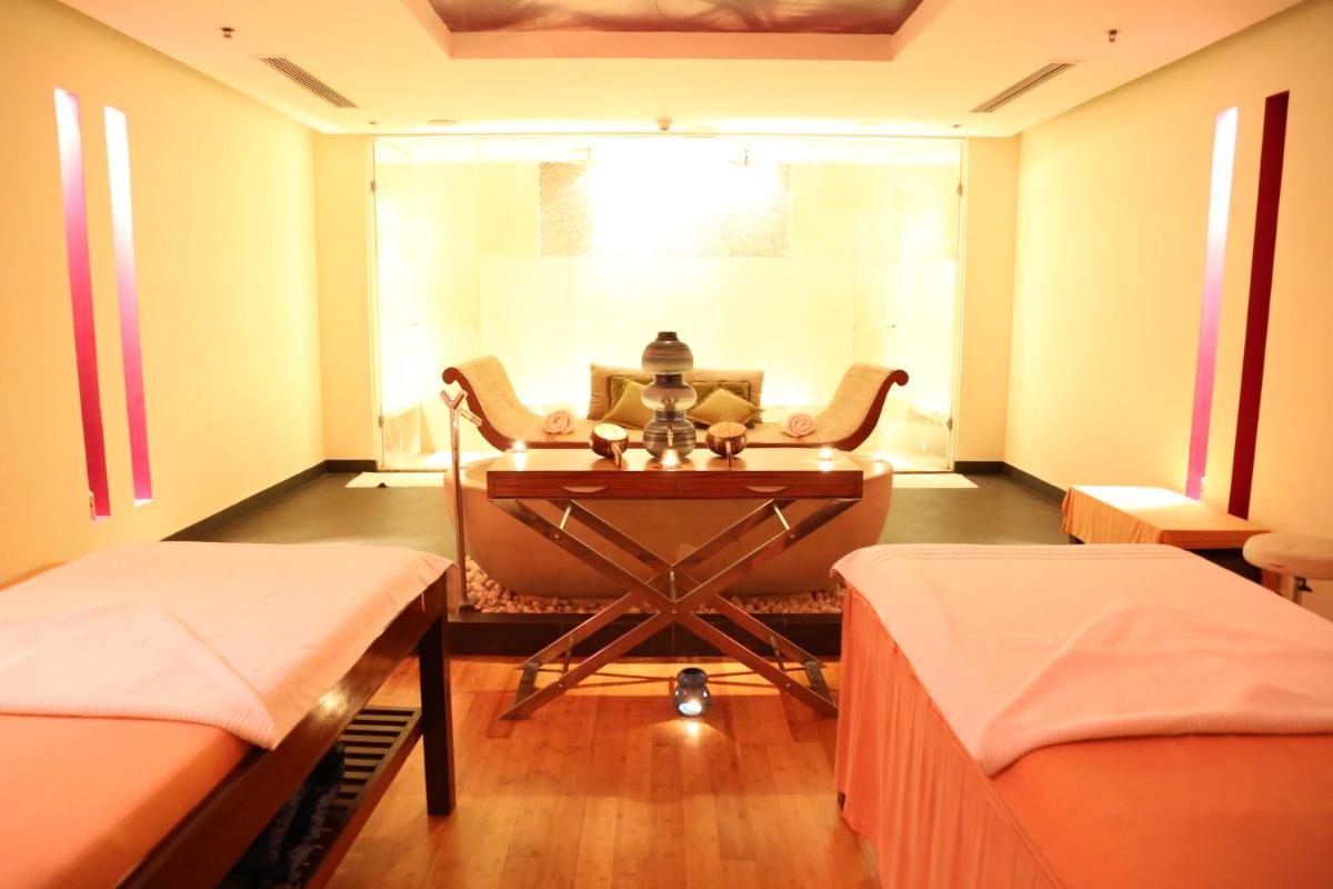 a hospital room with two beds and a table at JW Marriott Mumbai Juhu in Mumbai