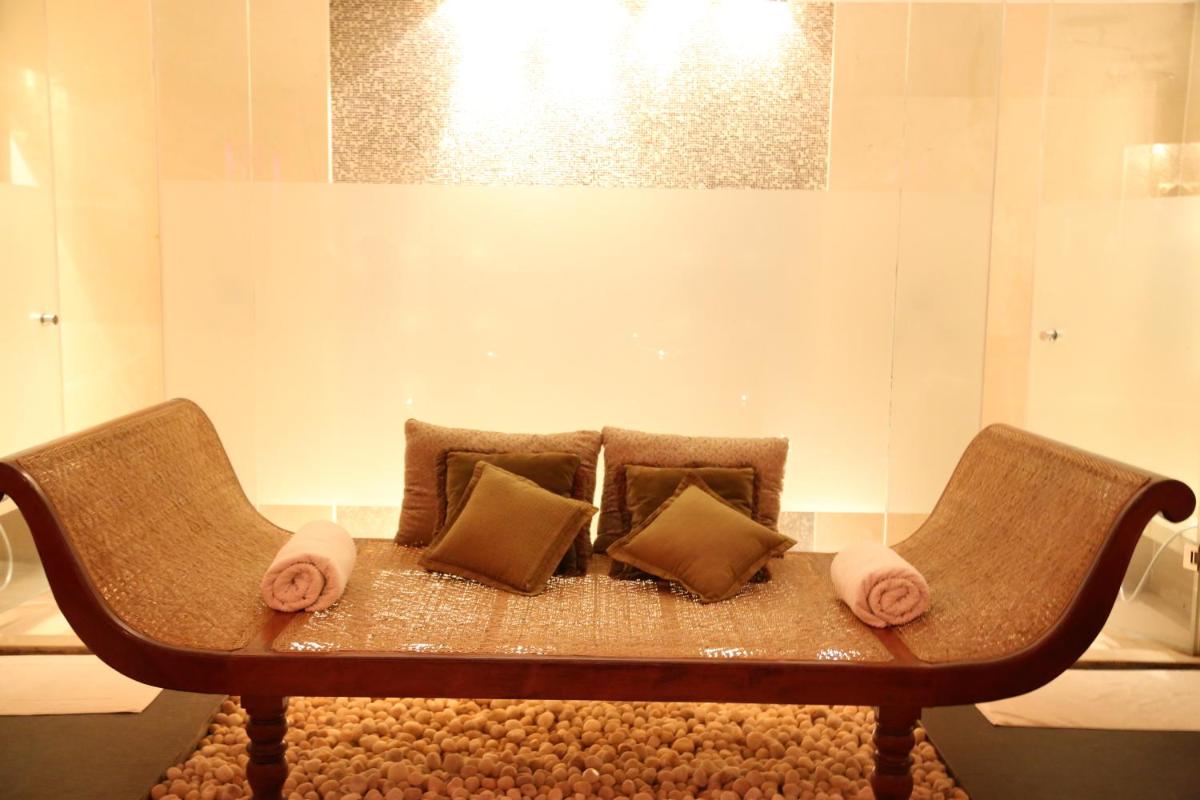 a couch with two pillows on it in a room at JW Marriott Mumbai Juhu in Mumbai