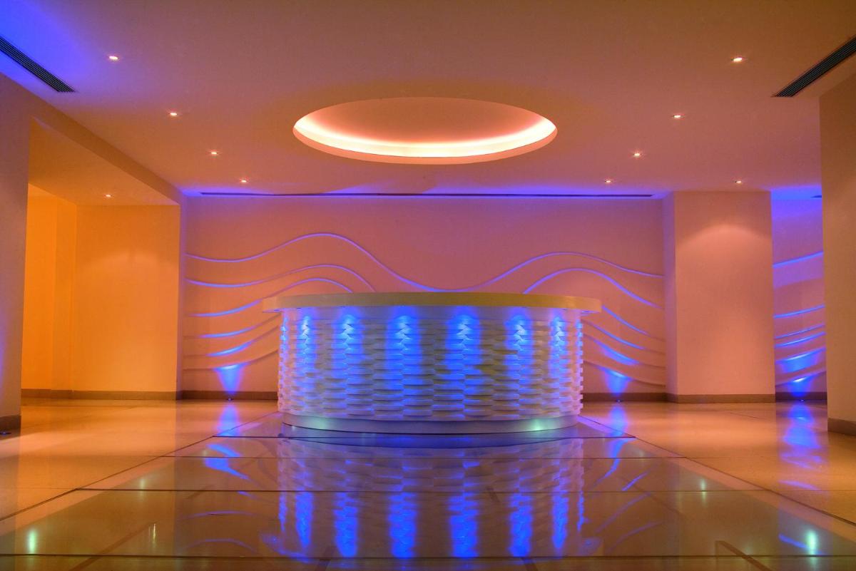 a lobby with a blue lighted table in a room at JW Marriott Mumbai Juhu in Mumbai