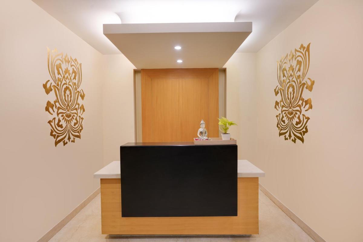 a reception desk in a room with a television at Lemon Tree Premier, Delhi Airport in New Delhi a reception desk in a room with a television at Lemon Tree Premier, Delhi Airport in New Delhi