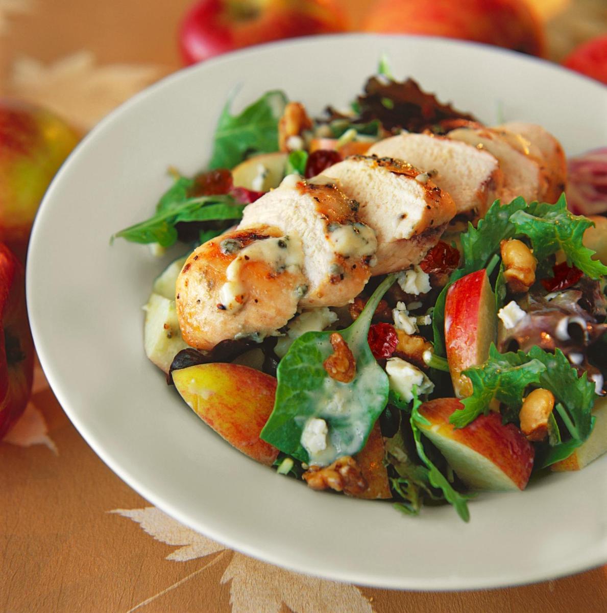 a white plate with a salad with shrimp and apples at Hilton Garden Inn, Trivandrum in Trivandrum