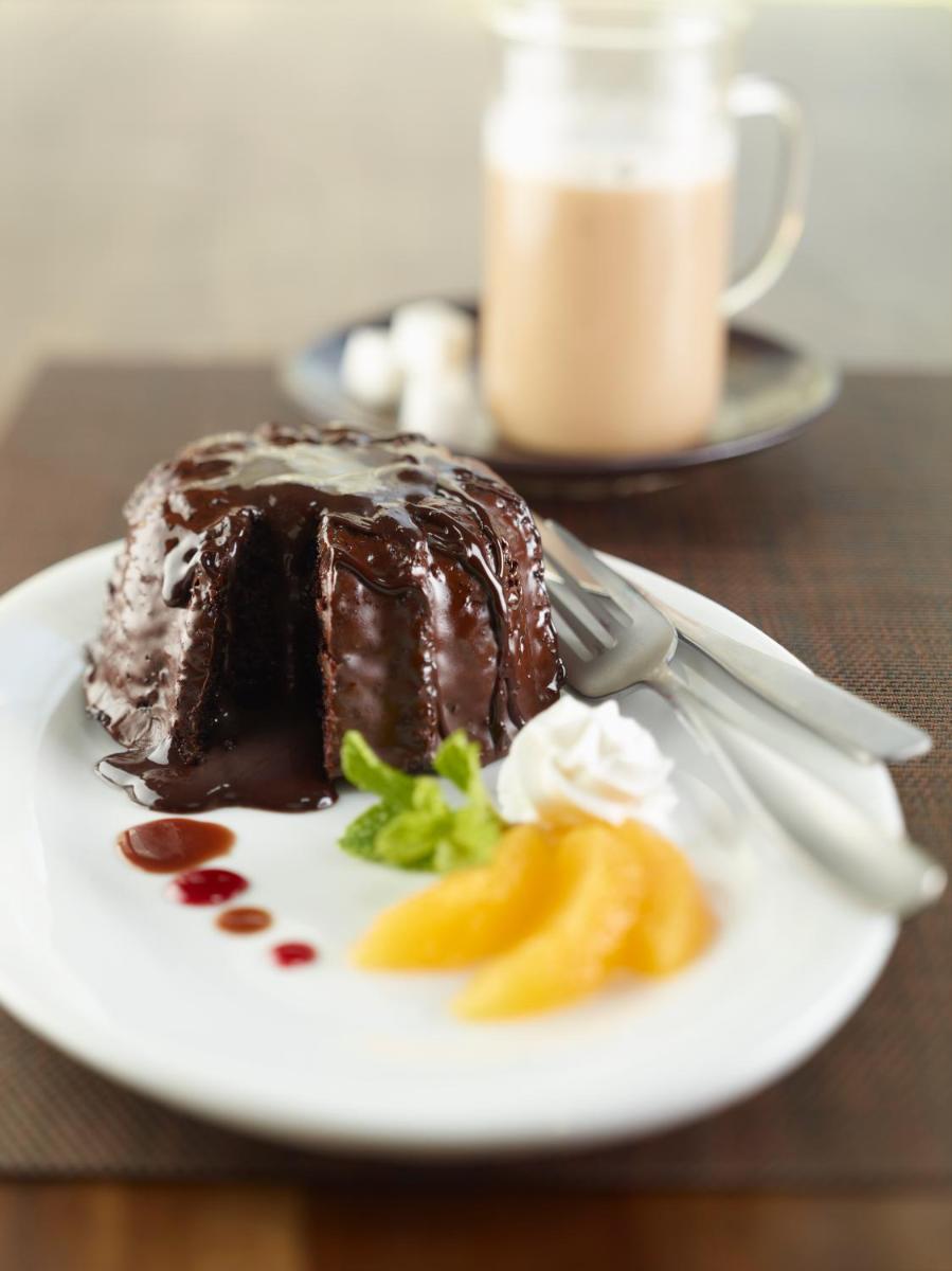 a piece of chocolate cake on a plate with a fork at Hilton Garden Inn, Trivandrum in Trivandrum