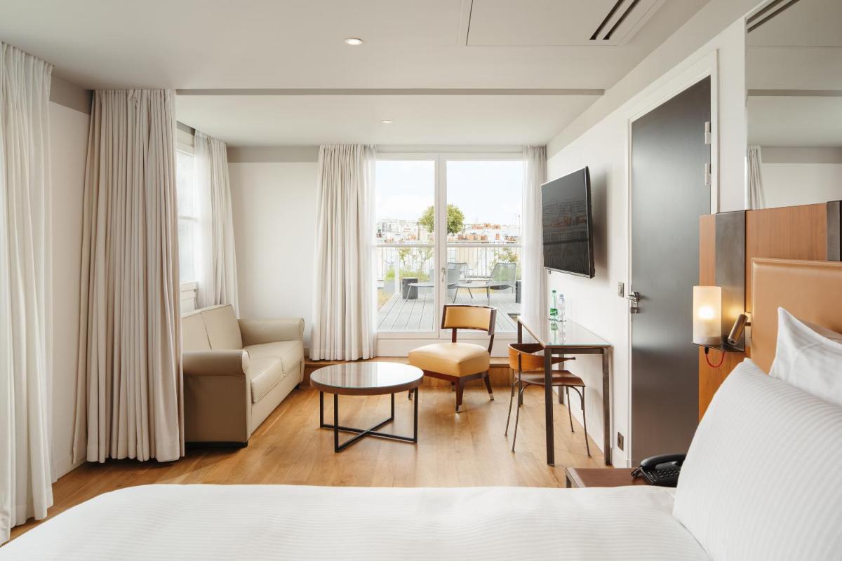 Un ou plusieurs lits dans un hébergement de l'établissement Boutet Bastille Hotel Paris - MGallery Collection