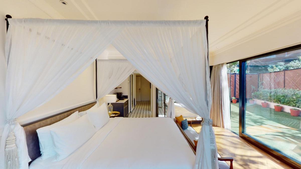 a bedroom with a canopy bed and a window at Radisson Hotel Shimla in Shimla