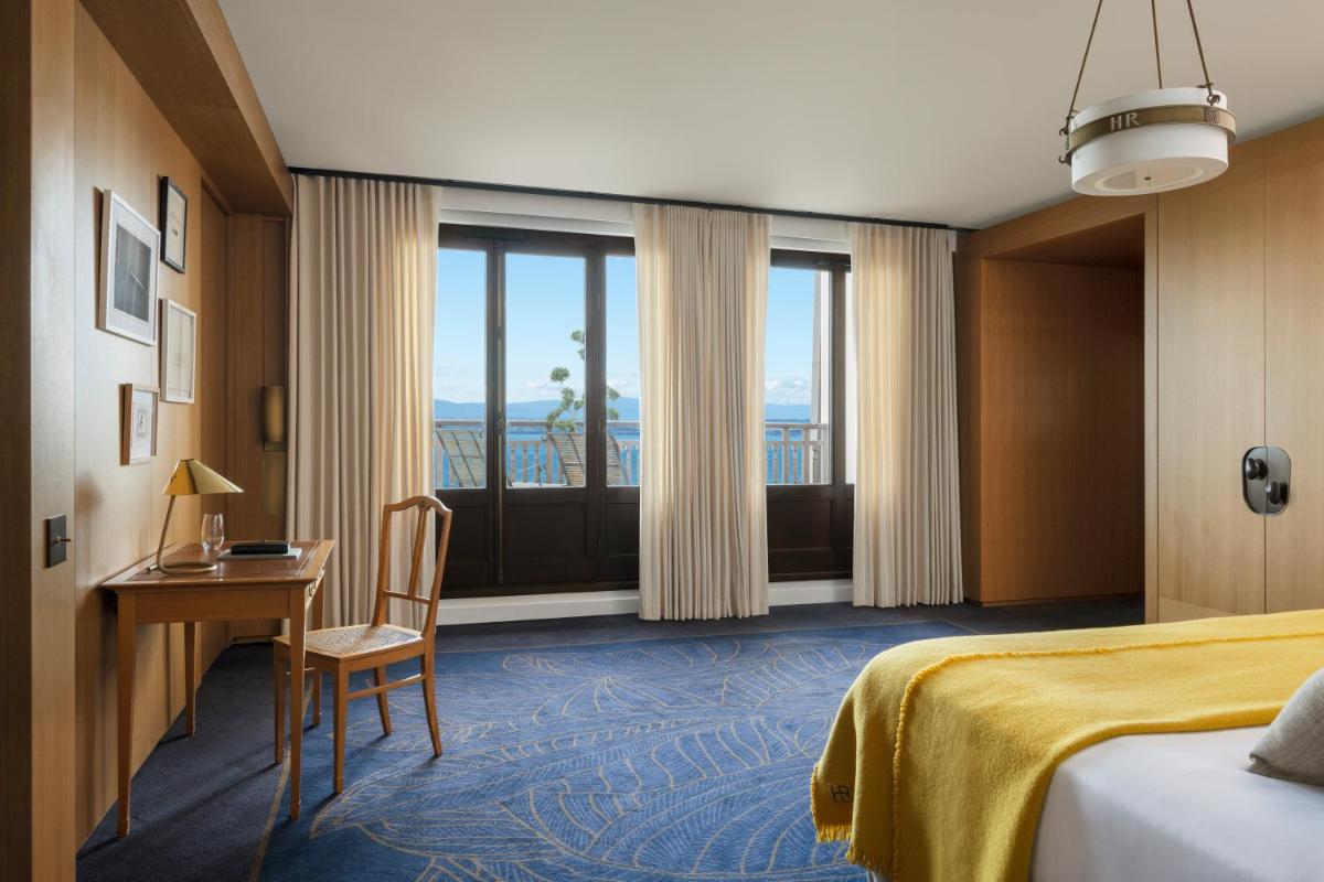 une chambre d'hôtel avec un lit, un bureau et une fenêtre dans l'établissement Hôtel Royal, à Évian-les-Bains