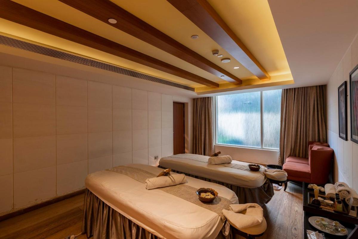 a hotel room with two beds and a window at InterContinental Jaipur Tonk Road by IHG in Jaipur