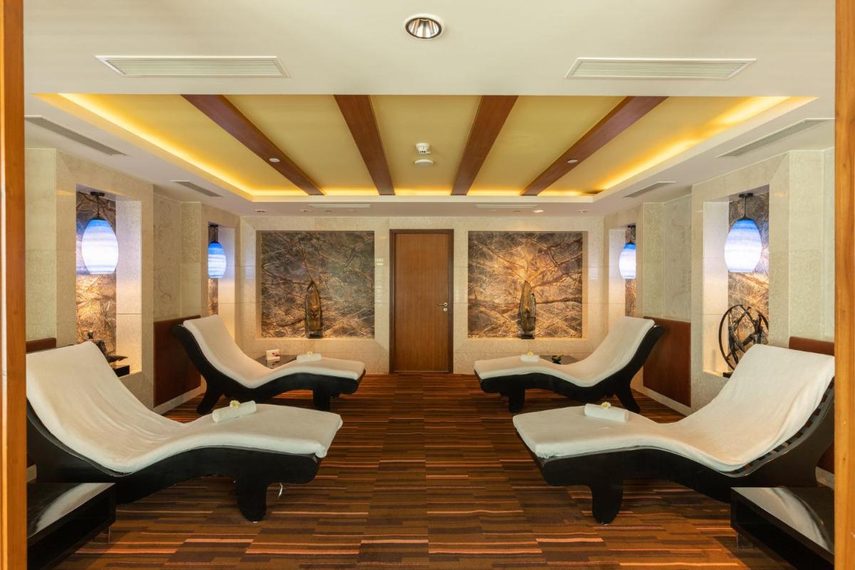 a waiting room with chairs and paintings on the walls at InterContinental Jaipur Tonk Road by IHG in Jaipur