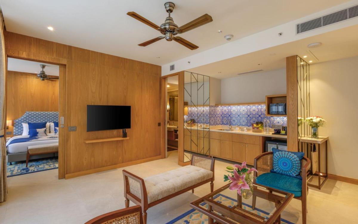 a room with a living room and a bedroom at The Astor - All Suites Hotel Candolim Goa in Candolim a room with a living room and a bedroom at The Astor - All Suites Hotel Candolim Goa in Candolim