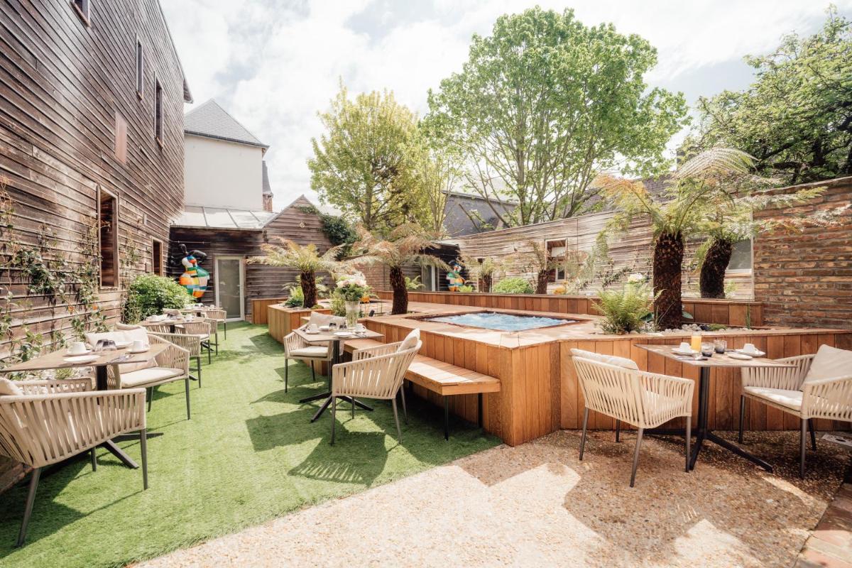 - un coin repas extérieur avec des tables et des chaises dans l'établissement La villa 10 HÔTEL SPA, à Étretat