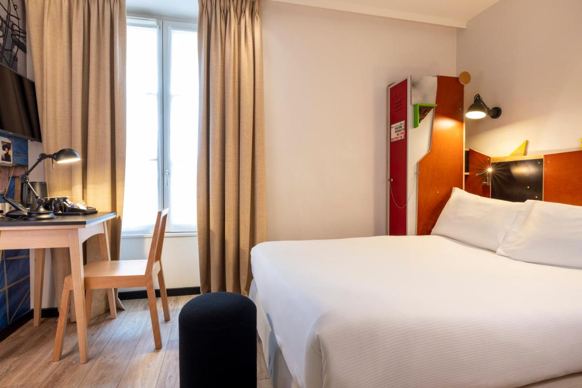 Un ou plusieurs lits dans un hébergement de l'établissement Hotel L’Antoine