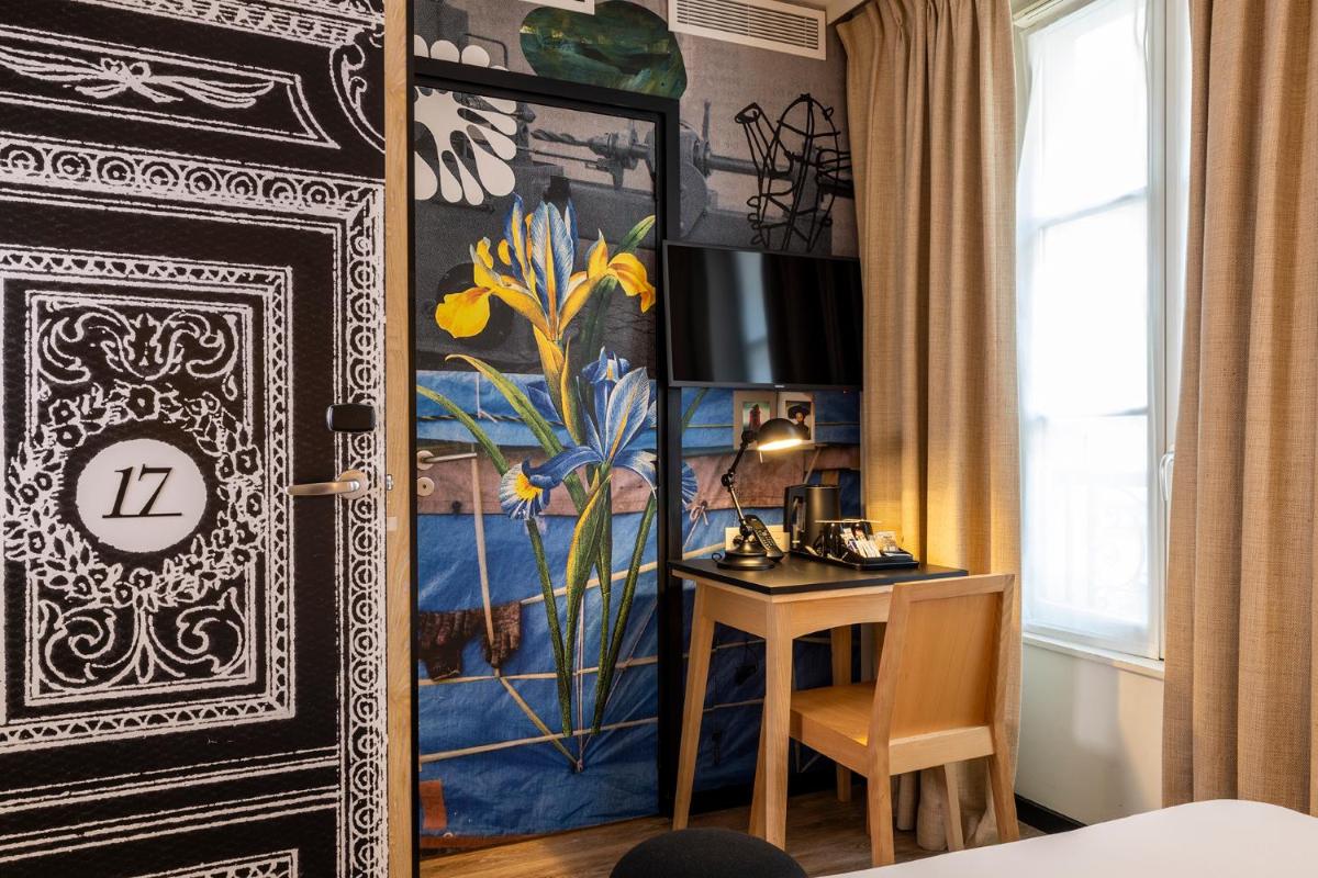 Un ou plusieurs lits dans un hébergement de l'établissement Hotel L’Antoine