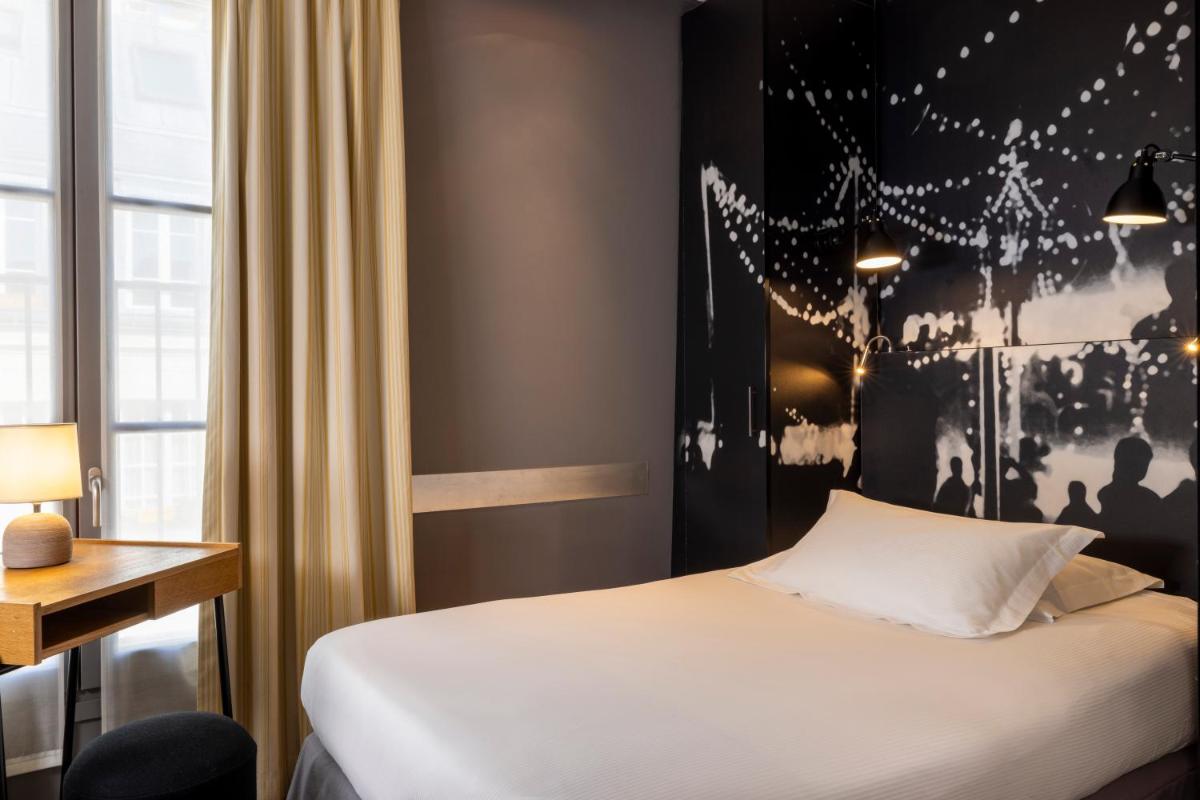 Un ou plusieurs lits dans un hébergement de l'établissement Hotel L’Antoine