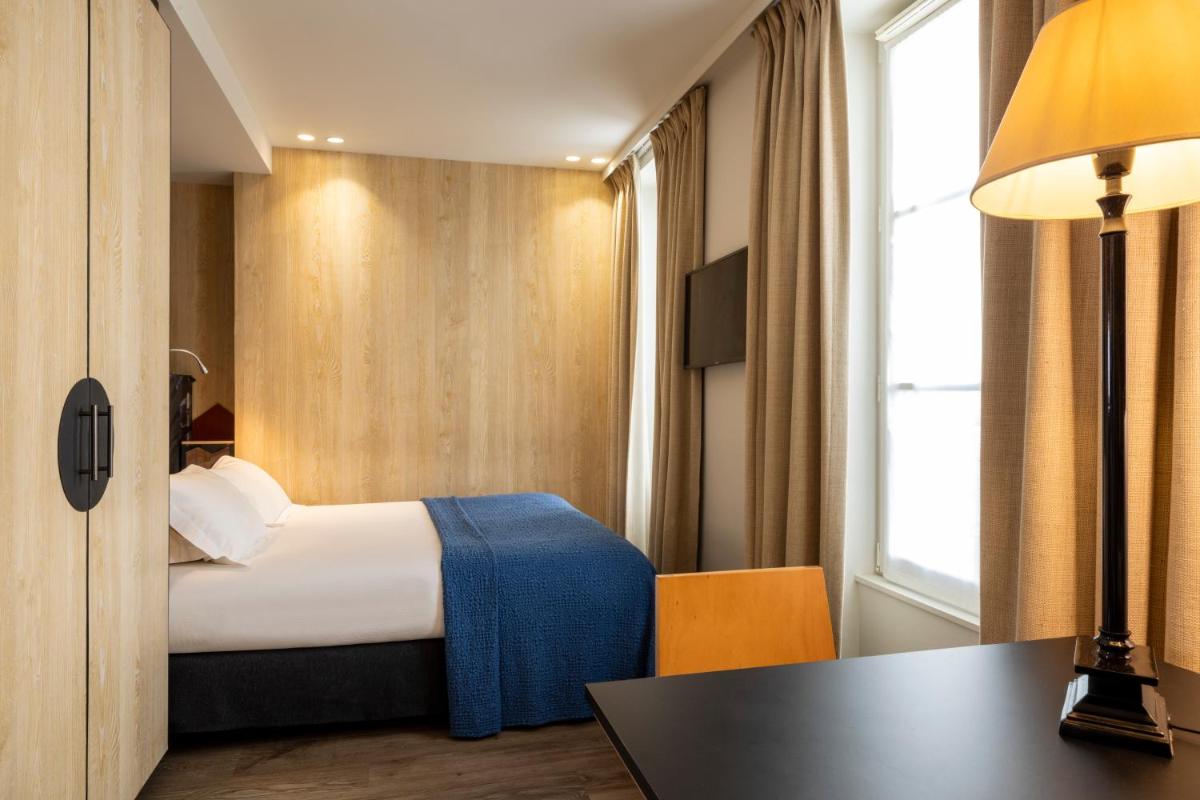 Un ou plusieurs lits dans un hébergement de l'établissement Hotel L’Antoine