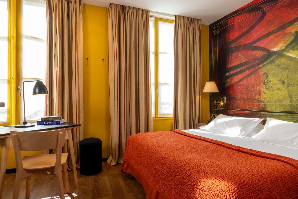 Un ou plusieurs lits dans un hébergement de l'établissement Hotel L’Antoine