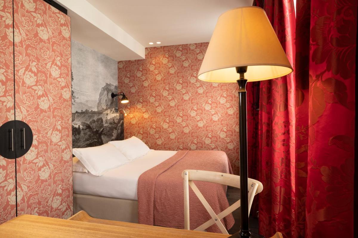 Un ou plusieurs lits dans un hébergement de l'établissement Hotel L’Antoine