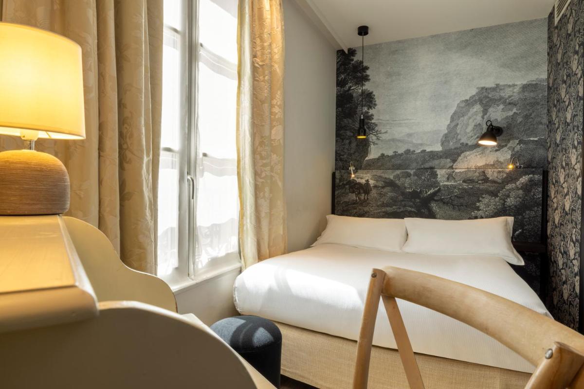 Un ou plusieurs lits dans un hébergement de l'établissement Hotel L’Antoine