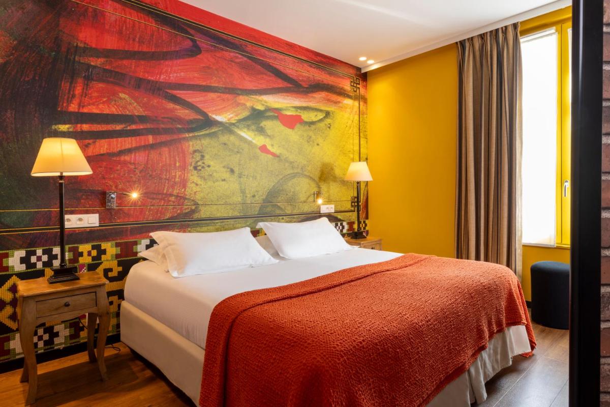 Un ou plusieurs lits dans un hébergement de l'établissement Hotel L’Antoine
