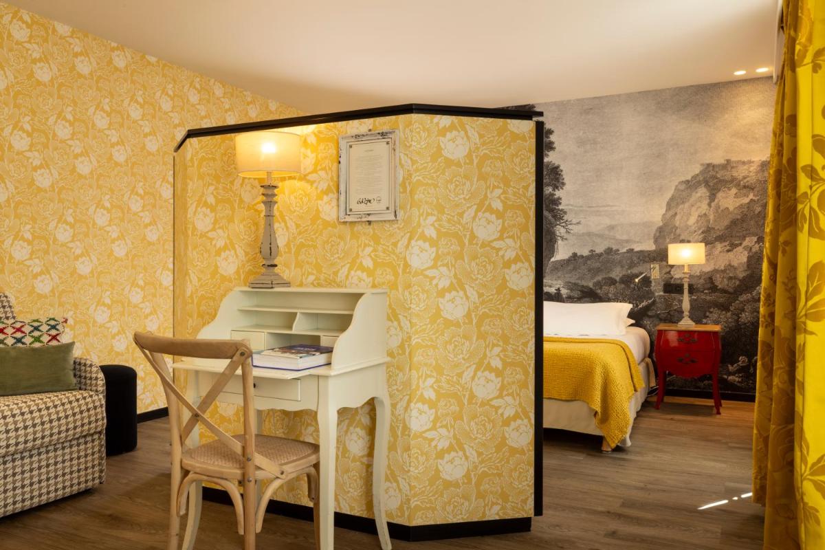 Un ou plusieurs lits dans un hébergement de l'établissement Hotel L’Antoine