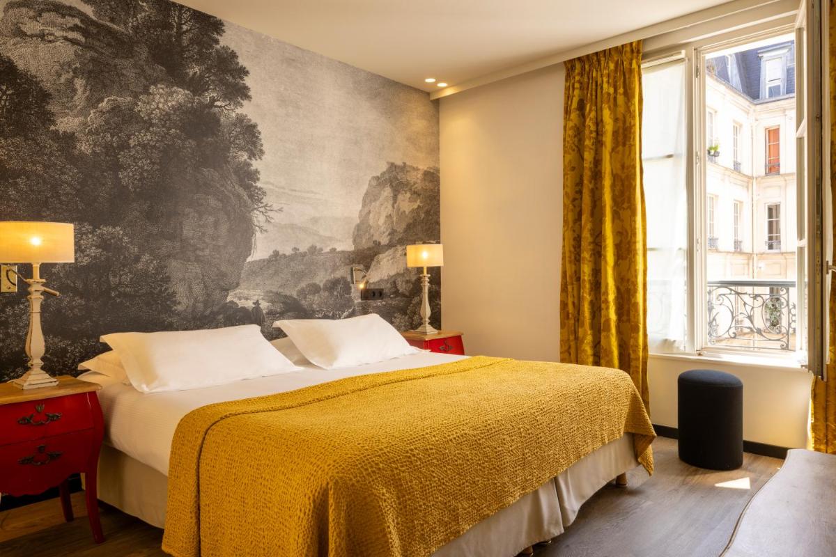 Un ou plusieurs lits dans un hébergement de l'établissement Hotel L’Antoine