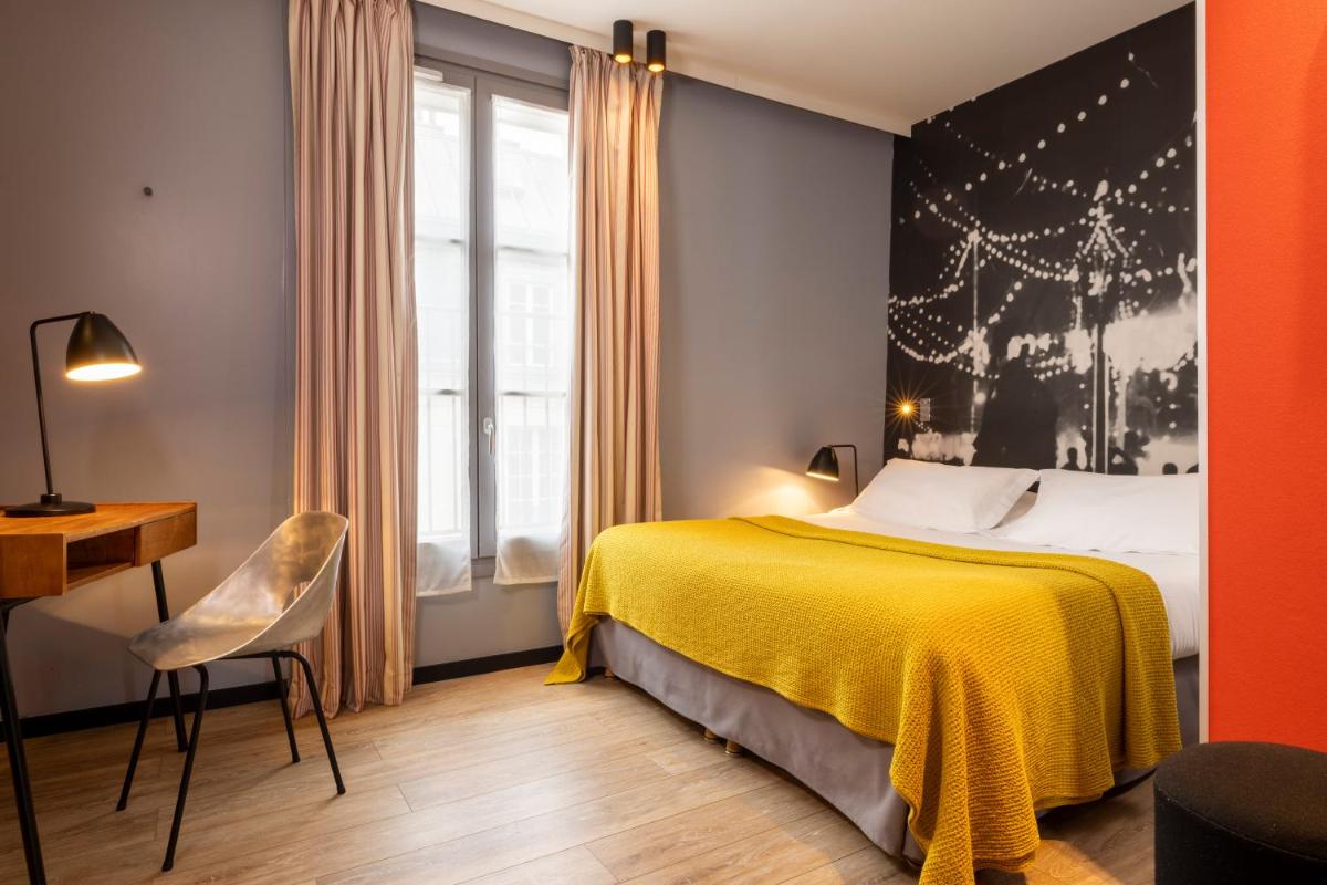 Un ou plusieurs lits dans un hébergement de l'établissement Hotel L’Antoine